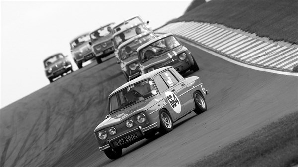 A Black and White photo of Renault 8 gordini and other cars